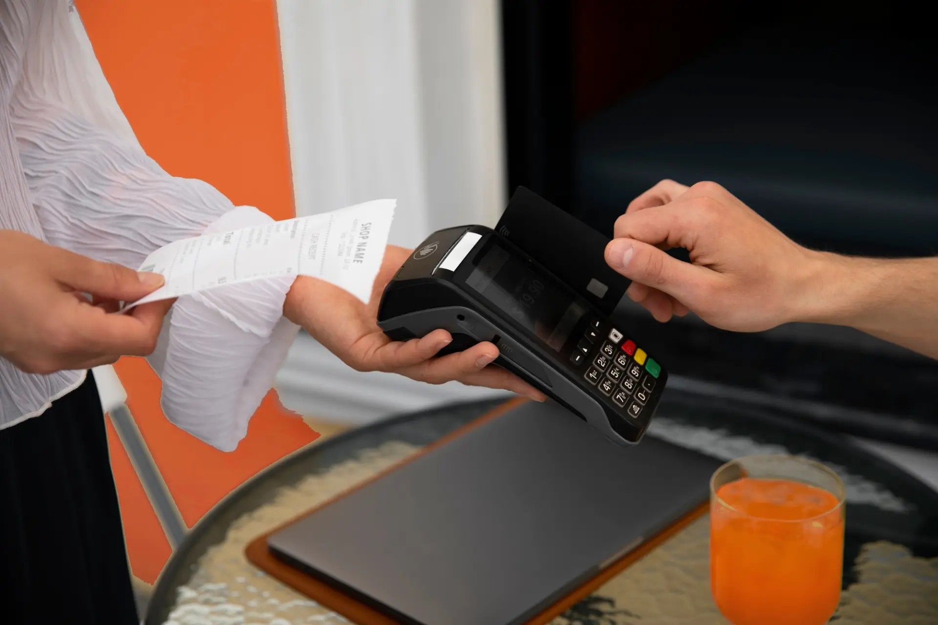 Woman is paying with card and gets a receipt.