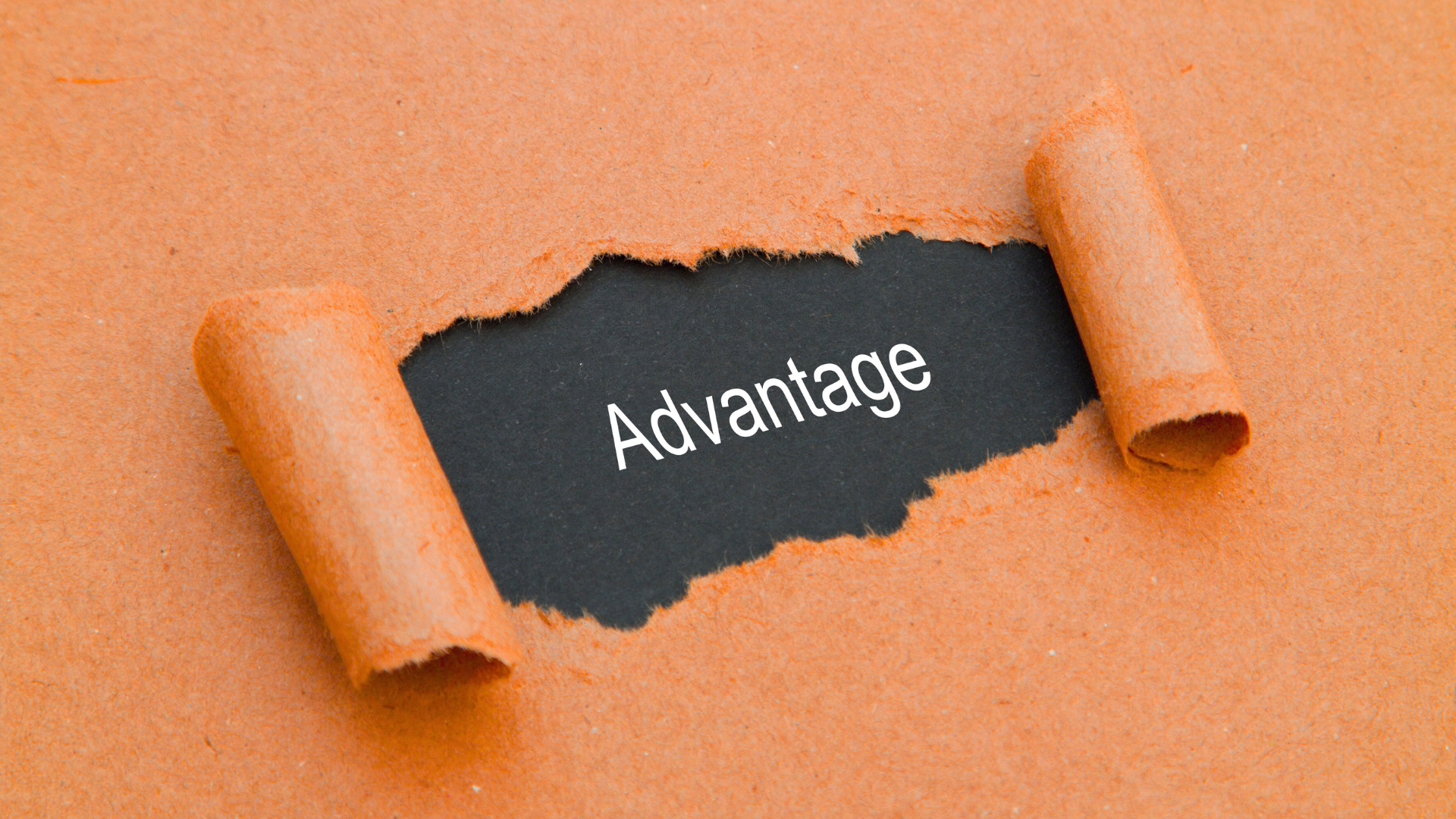 Orange paper torn to reveal the word "Advantage" on a black background